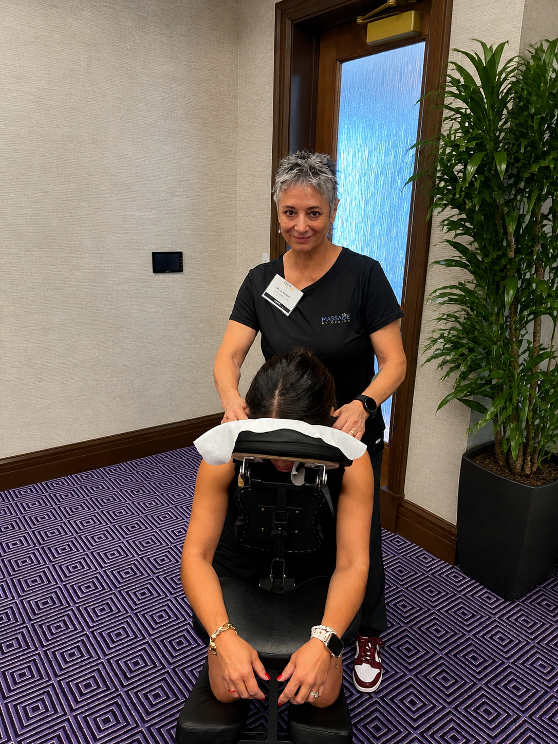 Onsite chair massage therapist working at an Austin, TX corporate conference