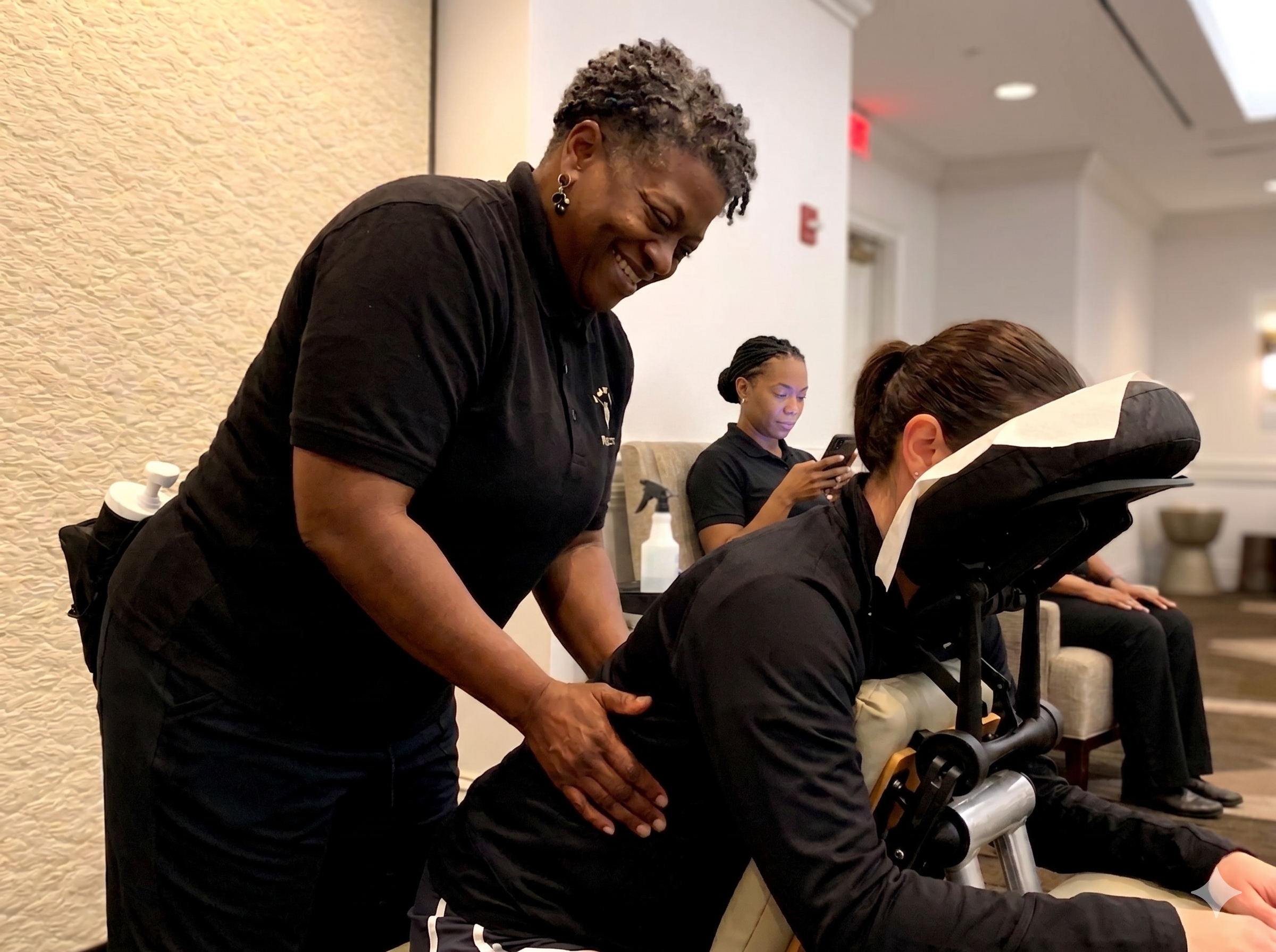 Onsite chair massage therapist working at a Dallas, TX corporate conference