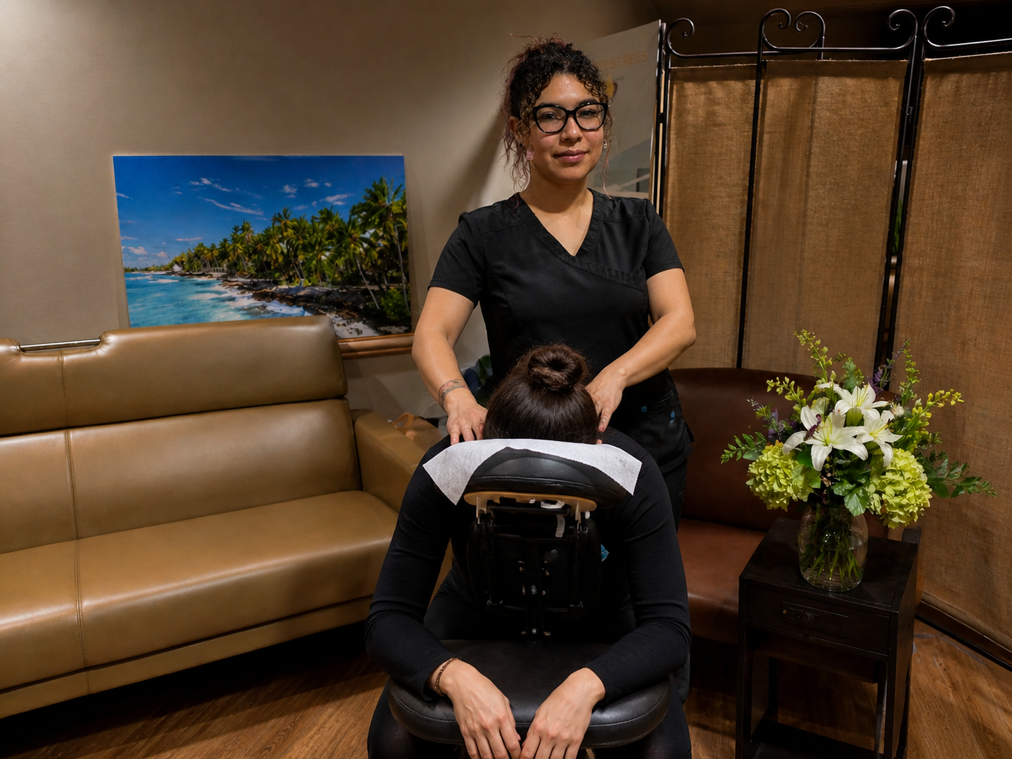 Licensed massage therapist providing onsite chair massage at a corporate event in Austin, TX